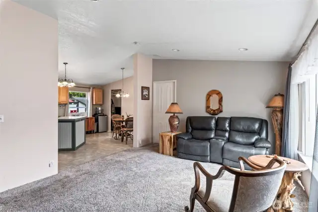 Comfortable seating area with natural light pouring in and a seamless flow into the kitchen.