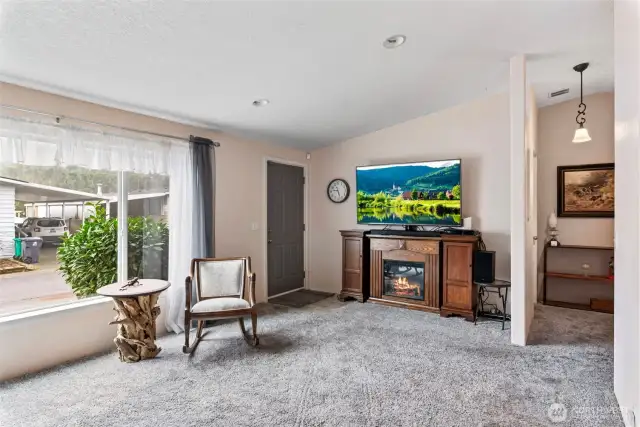 Warm and cozy living space with an electric fireplace and space for entertainment.