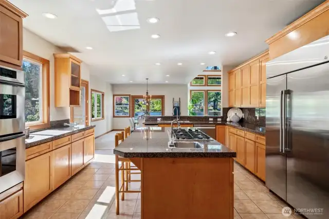 Large updated bright kitchen with stainless appliances and granite counters. Cabinets refinished, walk in pantry, separate desk area with more storage within the kitchen.