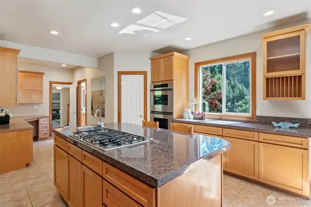 Bright eat in kitchen with the latest appliances, walk in pantry, desk area and 1/2 bath - door to side deck & yard too!