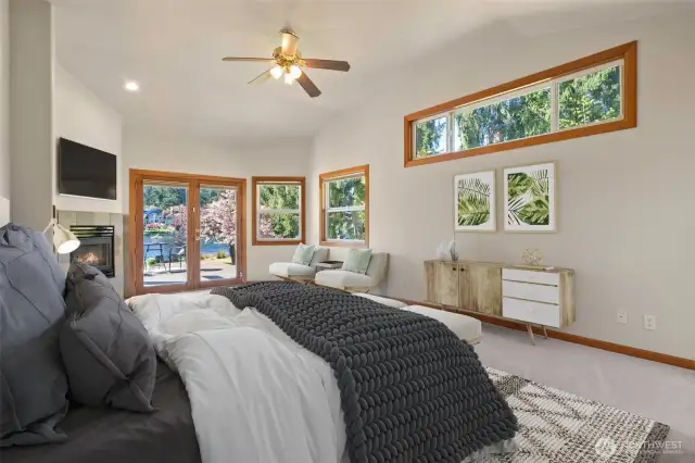Main Level large primary bedroom with gas fireplace, seating area, French doors to deck, dock and yard. Fresh Paint & Carpets through-out!