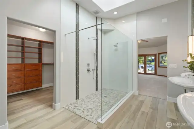 Large double sink ADA compliant primary bathroom with top fixtures, floors & lighting.