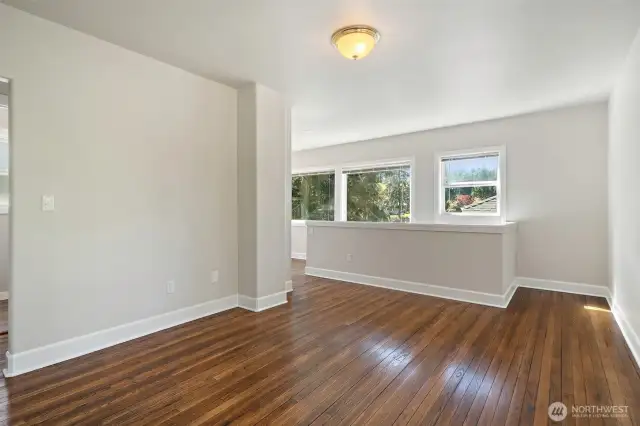 Upper level space with original gleaming hardwood floors - potential for guest bedroom or office, playroom - lots of possibilities! Shown here un-staged.