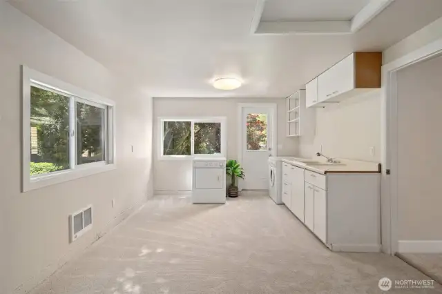 Laundry area on main level with sink - was original kitchen in the home, so great possibility for a 2nd kitchen. Easy access to backyard & 3 car garage.