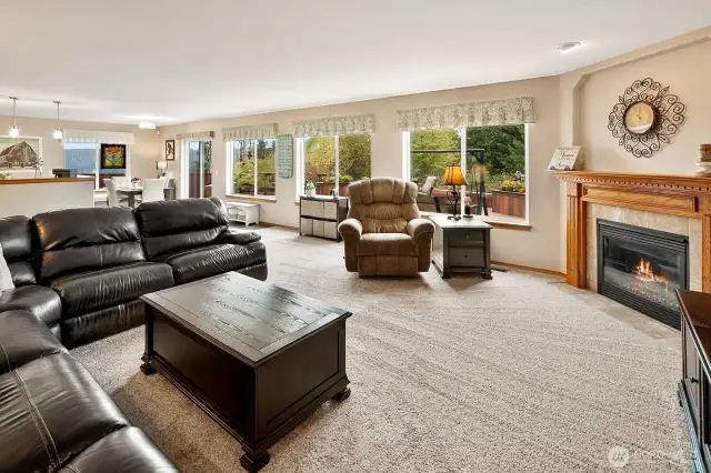 Gas fireplace warms up this cozy space. Large windows allow the natural light to flow in and provide peaceful, gorgeous views of the green belt and valley.