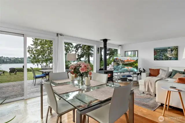 Main house living and dining room with cozy woodstove and water views!