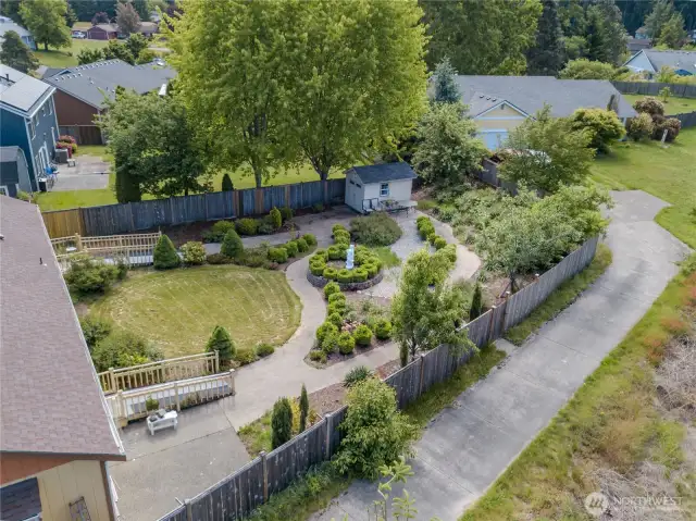 Enormous back yard gardens offer safe strolls amidst dozens of blooming roses and blooming fruit trees.
