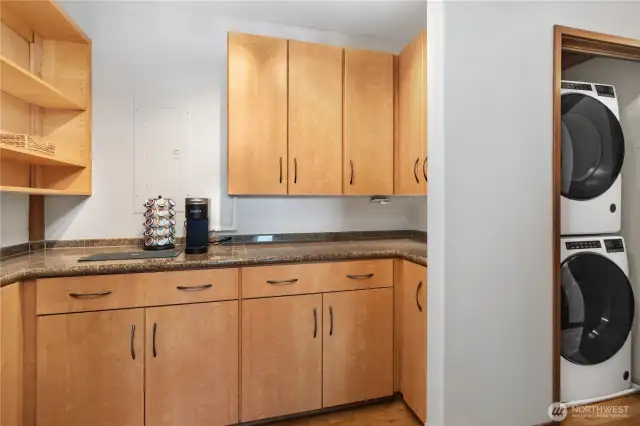 Butler's pantry with ample storage - a great place to make a coffee nook - plus stacked washer and dryer