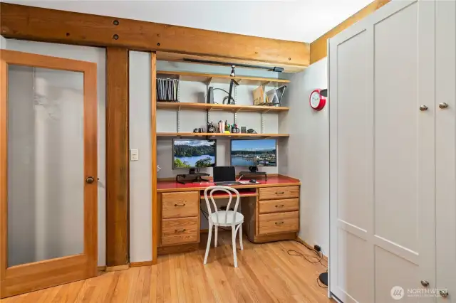 2nd bedroom offers built-in desk space, murphy bed, view of the trees, and ample storage