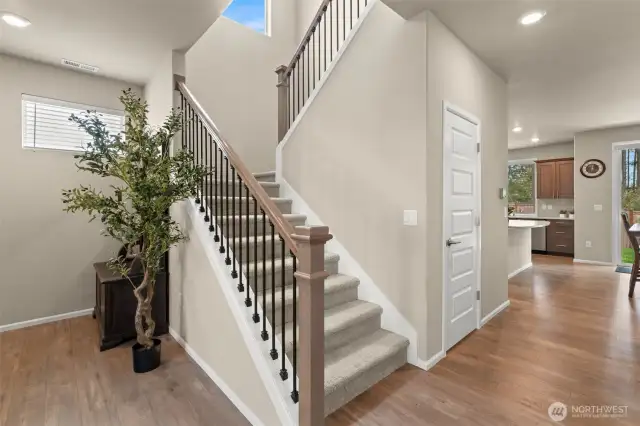 Warm and welcoming entryway with beautiful wood floors and a modern staircase—setting the tone for the rest of this thoughtfully designed home.