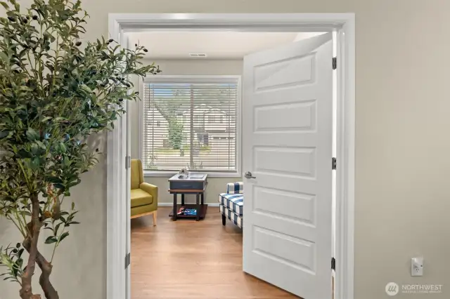 This bright and versatile front room offers the perfect spot for a home office, reading nook, or cozy conversation area—with natural light pouring in through the large window.
