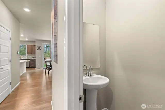 Convenient main-level powder room with a sleek pedestal sink—perfectly tucked away for guest use without sacrificing style or privacy