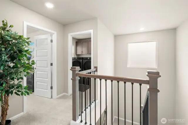 The upstairs landing offers convenient access to the laundry room and bedrooms, complete with stylish finishes, plush carpeting, and a functional layout designed for everyday ease.