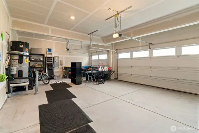 Spacious three-car garage with room for storage, tools, and weekend projects—plus a clean, finished look and natural light from upper windows for added functionality.