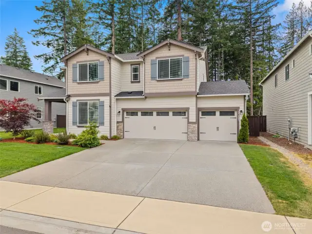 Curb appeal for days! This beautifully maintained two-story home features a 3-car garage, charming shutters, and lush landscaping—all set against a tranquil greenbelt backdrop for added privacy.