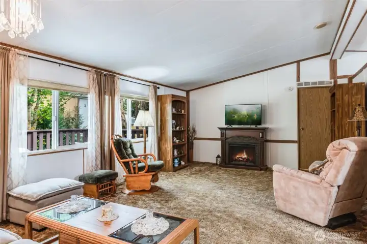 Bright and open living room with vaulted ceilings and large windows for natural light.