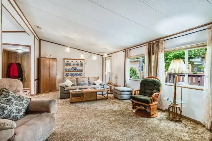 Large, double-paned vinyl windows bring in natural light to highlight the open living area.