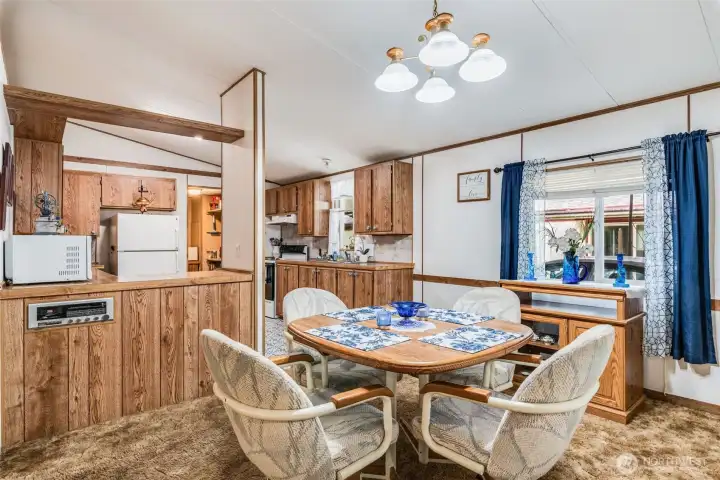 Bright dining area with vaulted ceilings is perfect for everyday meals or entertaining.