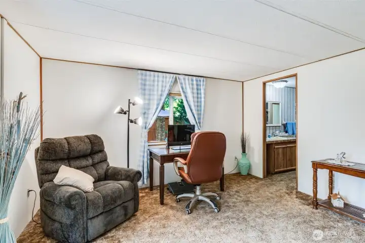 Primary suite offers extra space for seating, desk, or flexible use.