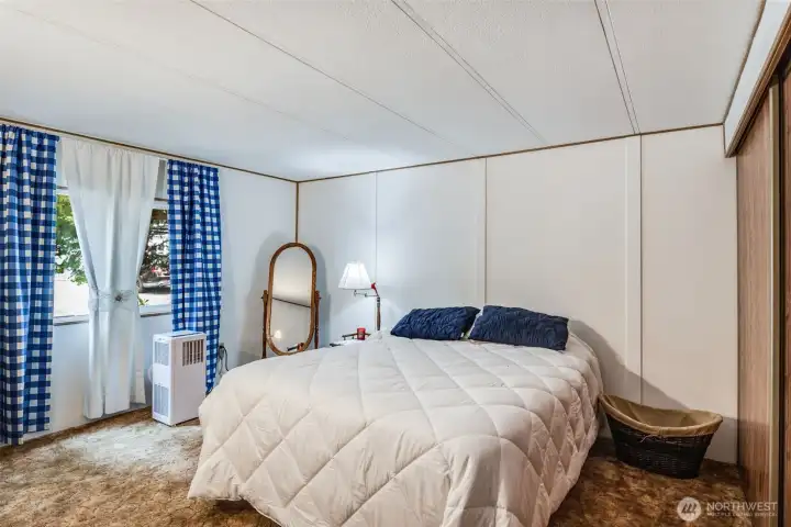 Secondary bedroom with large window and natural light.