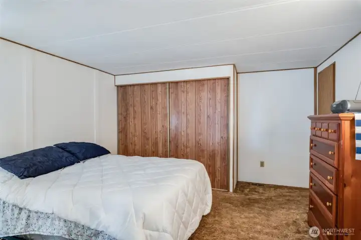 Another view of the secondary bedroom highlighting the spacious closet and layout.