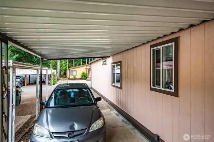 Extended carport offers shade and protection for vehicles.