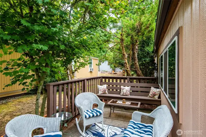 Outdoor seating deck creates a private spot for relaxing or dining.