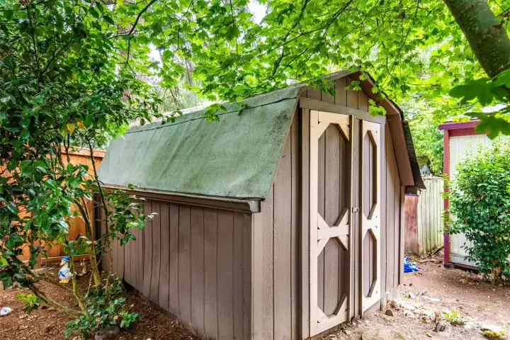 Detached storage shed with shelving provides space for tools, hobbies, or seasonal items.
