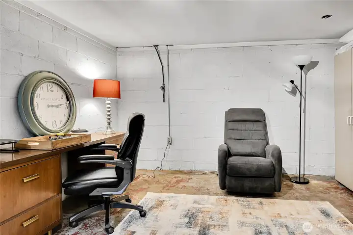 Unfinished space in basement for den/office, hobby room.