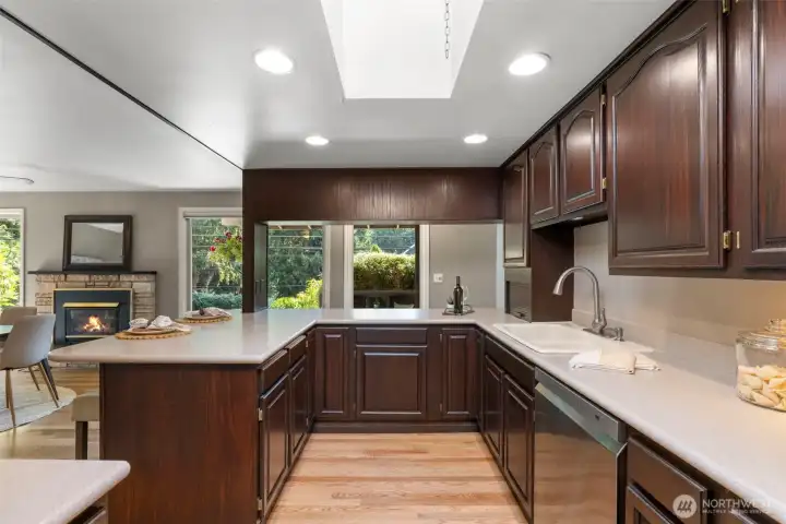 Ample counter space and cabinets! Plus a HUGE skylight for added natural light! Great open concept space into the eating area with fireplace