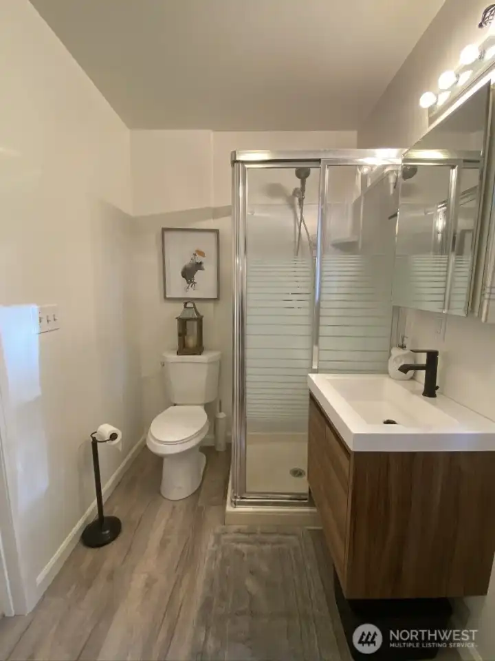 Studio bathroom also includes stack washer and dryer (not shown in photo, located on opposite wall)