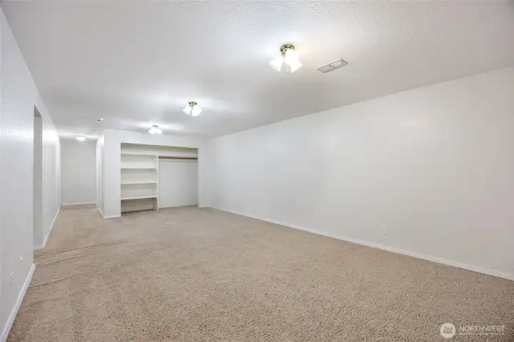 Basement large family room has build in storage.