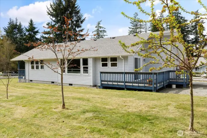 Back deck access through dining area sliding glass doors, or exterior side of home.