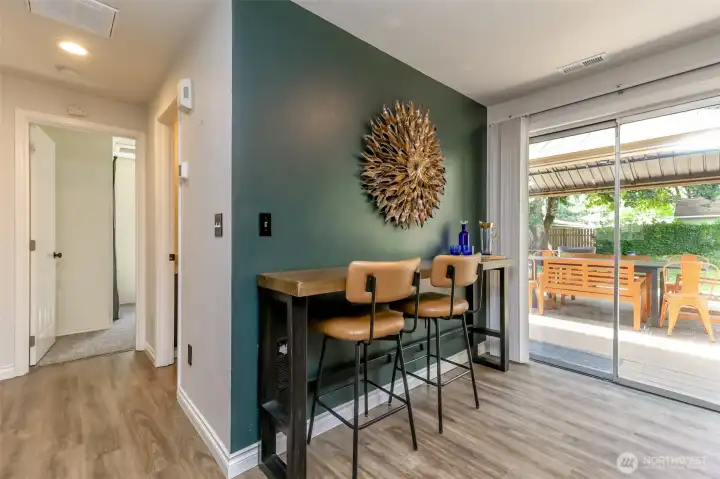 Dining area featuring a custom natural raw-edge serving bar. Bar and stools are included with the sale if desired.