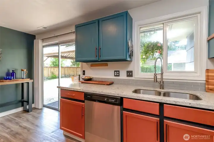 View of the custom-painted kitchen featuring durable and beautiful laminate flooring.