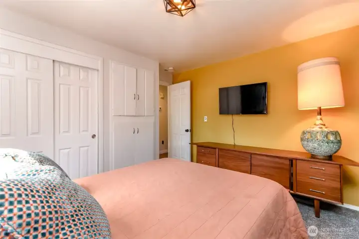 This secondary bedroom is remarkably spacious and includes both a large closet and delightful, original built-in cabinetry.