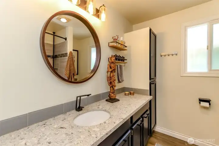 Updated main bathroom featuring ample storage and generous counter space.