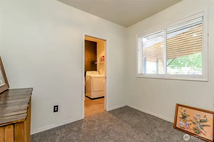 This is the fourth bedroom, which also functions as a family room or media room and features direct access to the laundry room.