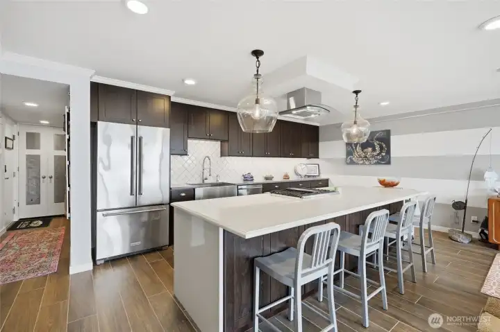 Stunning chef's kitchen with oversized island and stainless steel appliances. Stunning chef's kitchen with oversized island and stainless steel appliances.
