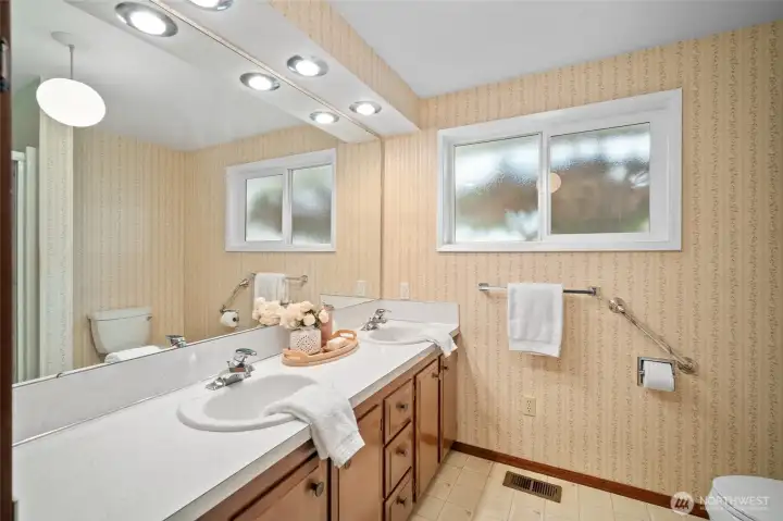 The full bathroom has ample storage space.