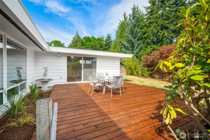 Mature landscaping surrounds the deck.