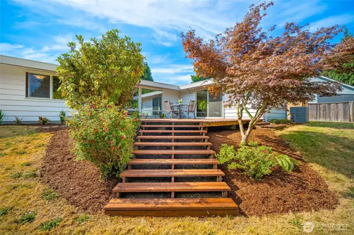 Inviting stairs to the deck from the backyard.