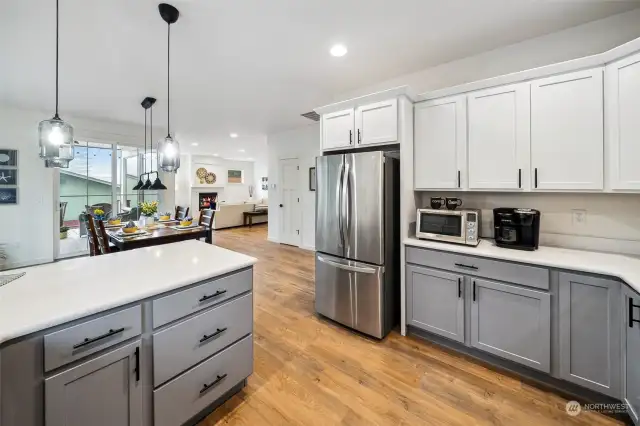 Deep drawers below the extended counter hold dinnerware and more with easy serving, too. The stainless appliance package is all included. No need to buy a fridge in this rarely use vacation kitchen waiting for your favorite recipes.