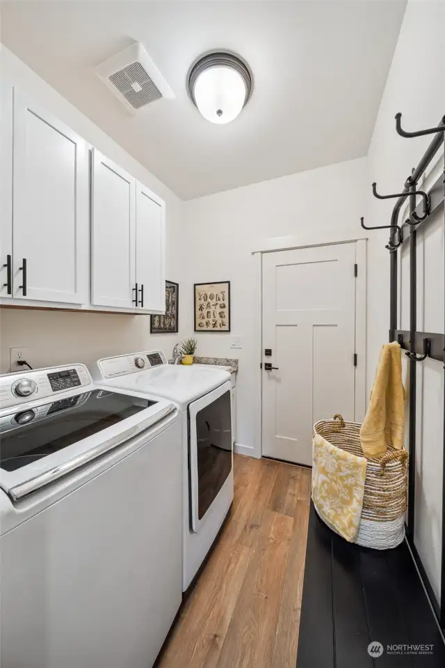 Place a coat and shoe rack here on the way to the garage. Plenty of space to share with almost new, rarely used washer and dryer, and convenient utility sink.