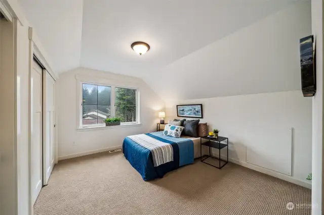 One of two large upper bedroom spaces, this overlooks neighbor's lot and the western skies. Great spot for an upper office, art room, exercise room, quilting or sewing corner, and more.