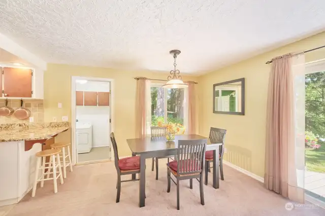 Dining area with laundry room beyond and great views of the trees and yard