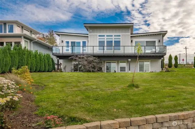 Modern design with Metal roof, Hardie siding, end to end composite decking, daylight basement, air conditioning and private beach access