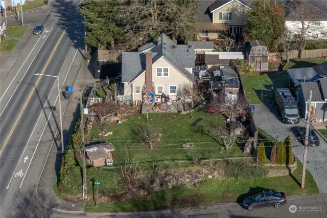 Set on a large corner lot, this Tudor-style home invites you to bring your vision to life and make it your own.