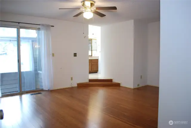 Double doors lead into the primary suite.  Suite has bamboo floors, a slider to the atrium, double closets, a wall AC unit, and a soaker tub.