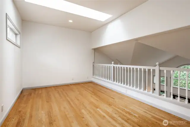 Staircase leads to loft space that overlooks living room.